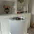 ScandiFlames Dualis bioethanol fireplace with a white fireplace body and a cylindrical safety glass