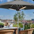 Black electric patio heater mounted on a parasol